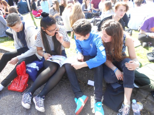 Students looking at a prospectus